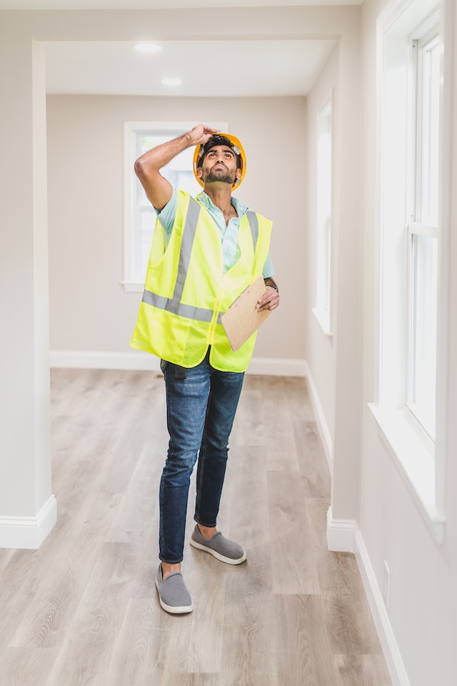 home inspector evaluating home ceiling